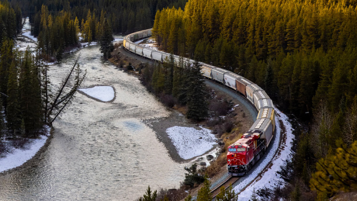 A train riding tracks in a snowy area.